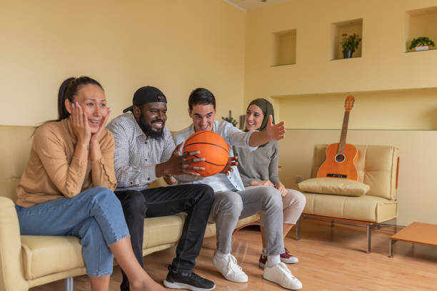istock Enthusiastic Multi-Ethnic Friends are Supporting Basketball Team from Home. 1300130940