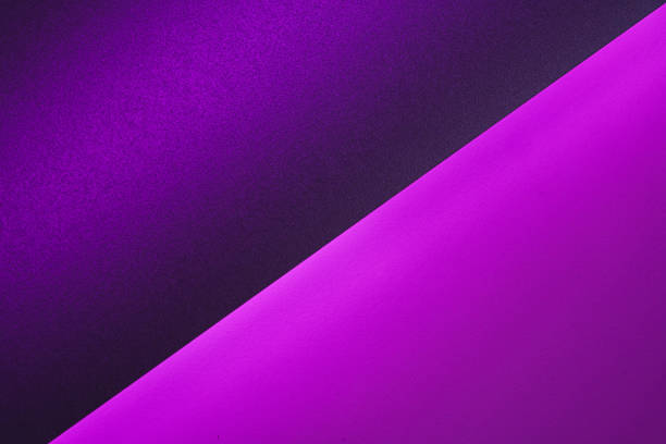 istock Blank paper sheets rolled in a neon purple lighting 1300131228