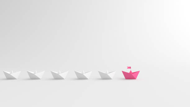 Woman leadership concept, pink leader boat leading white boats, on white background with empty copy space stock photo