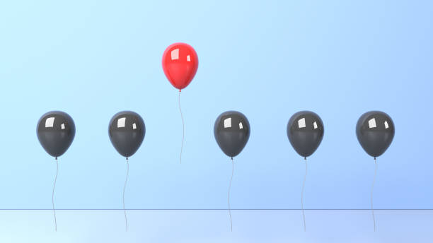istock Standing out from the crowd and different concept, red and black balloon on blue background 1300132419