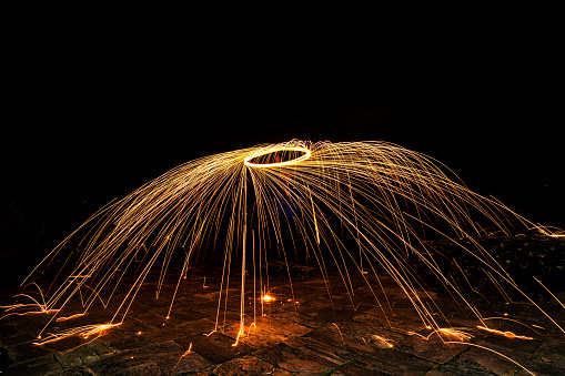 Dramatic firewheel created by women whirling a sparkler in a circle.
