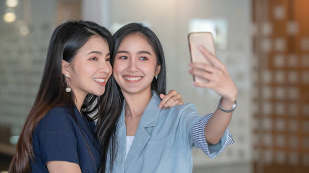 istock Two beautiful women taking selfie in cafe. 1300134279