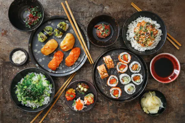 Photo of Traditional Japanese Dishes. Sushi and Sushi Roll Set. Rice Bowls. Tuna Tataki.