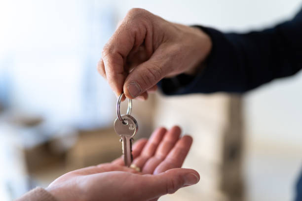 istock State agent giving keys to a new lady's house 1300135739