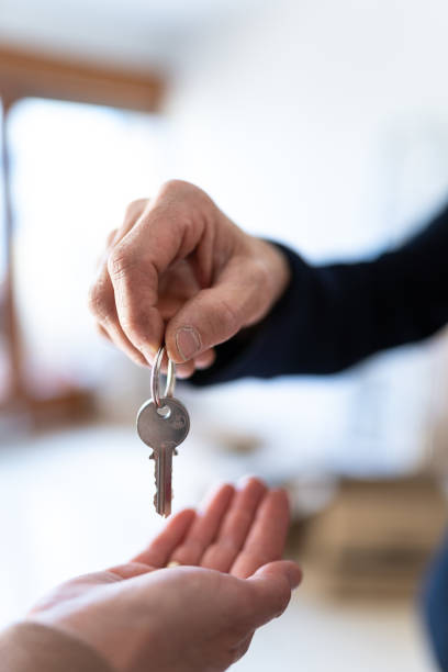 istock State agent giving keys to a new lady's house 1300135741