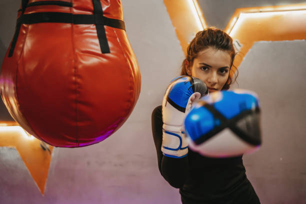 istock Female boxer training with a punching bag 1300135754
