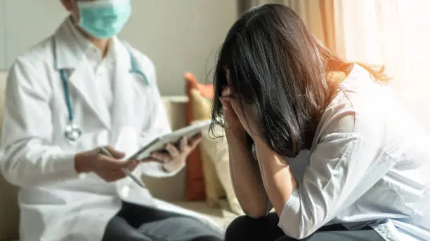 Photo of Panic attack menopause woman, stressful depressed PTSD patient with anxiety disorder having consultation psychotherapy treatment session in doctor clinic or psychologist counselor office