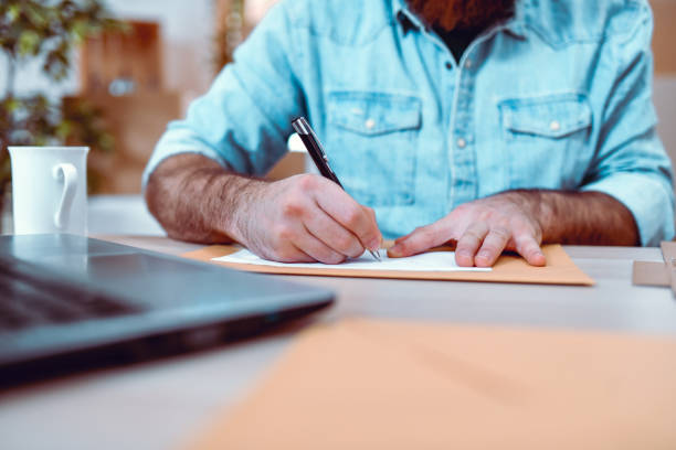 istock Office Clerk Writing Destination To Letter Back In Delivery Office 1300136916
