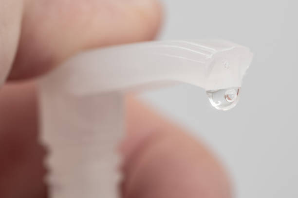 istock Close up of a hand sanitiser pump with fingers 1300139236