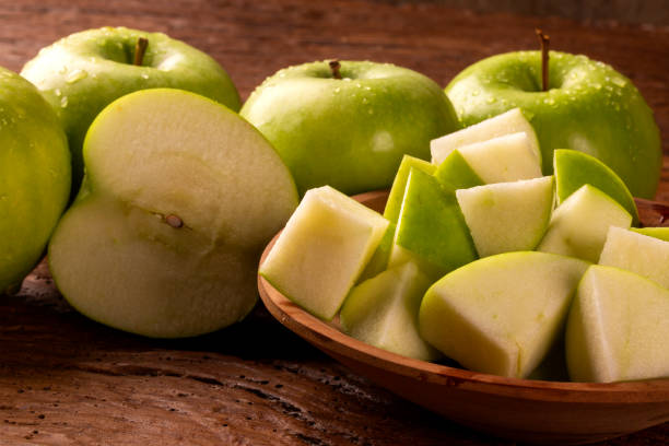 istock Ripe green apples on table close up 1300141523