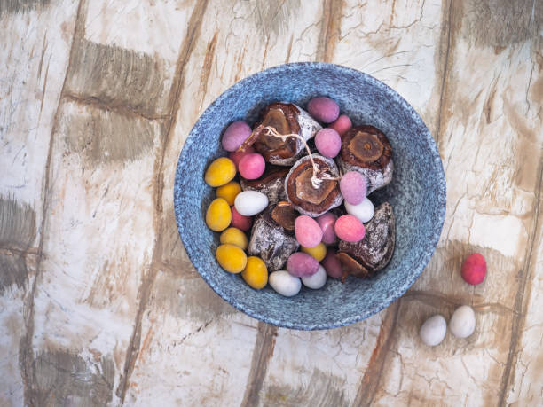 istock Chocolate eggs and dried persimmon in a gray ceramic plate on a light table in rustic kitchen 1300143739