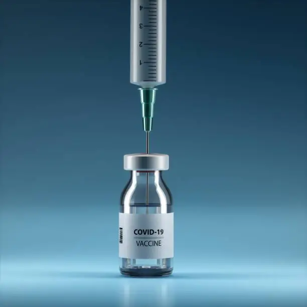 Photo of Syringe and Bottle on blue background