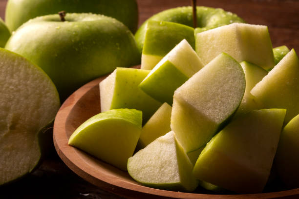 istock Ripe green apples on table close up 1300144011