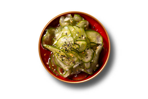 Sunomono - Japanese Cucumber Salad with sesame seeds. Isolated top view. Sunomono - Japanese Cucumber Salad with sesame seeds. Isolated top view sunomono stock pictures, royalty-free photos & images