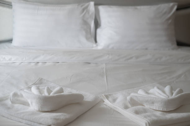 istock Close up white towel on the bed table in luxury modern hotel room 1300150042