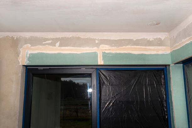 istock Installation for external roller shutters made of plasterboard inside the building, windows are covered with protective foil. 1300150684