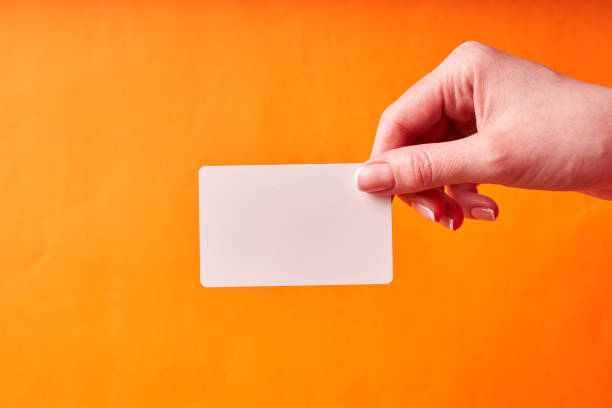 istock A woman's hand holds a white plastic card. Isolated card in hand 1300151799
