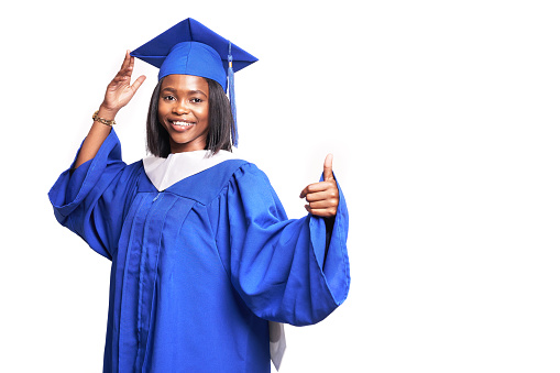 African-American beautiful woman in a blue robe and hat, on a white isolated background smiles and shows thumb up