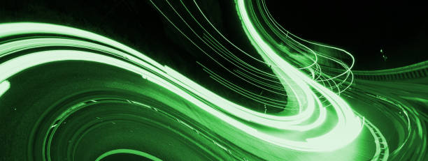 istock green car lights at night. long exposure 1300153582