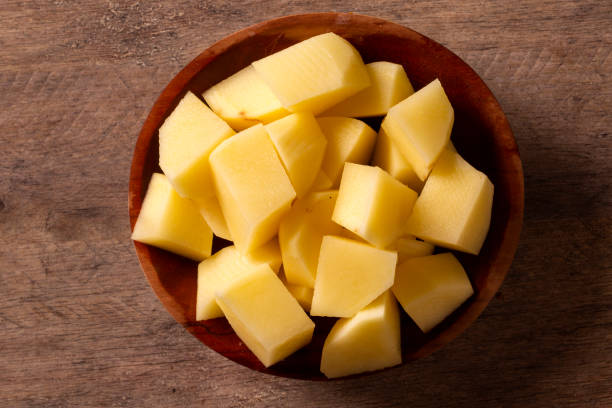 istock Potatoes and potato sliced on wooden table. Selective focus 1300153742
