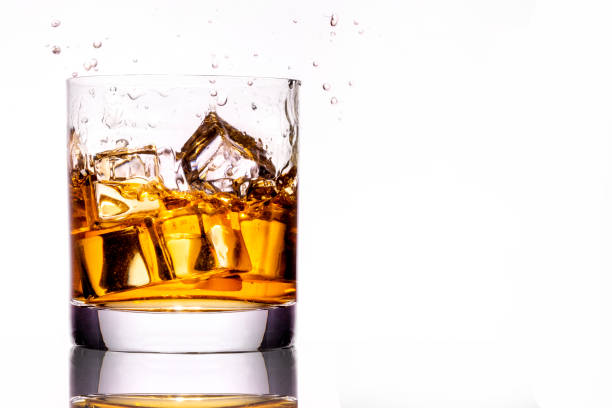 istock Whiskey glass with splash, isolated on white background 1300154939