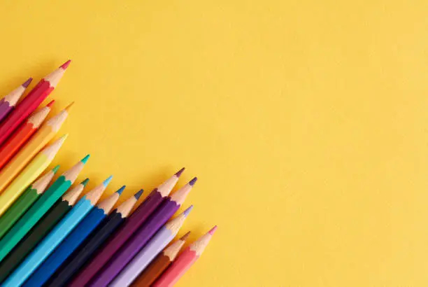Photo of Colored pencils on the yellow background