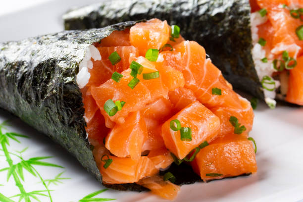 суши из лосося темаки на белой тарелке на белом фоне - temaki food sushi salmon стоковые фото и изображения