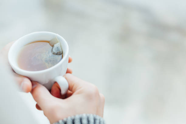 istock Man Holding A Cup Of Hot Tea 1300158143