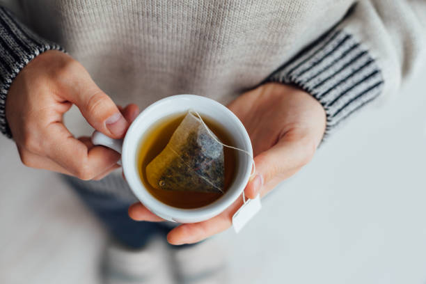 istock Man Holding A Cup Of Tea 1300158735