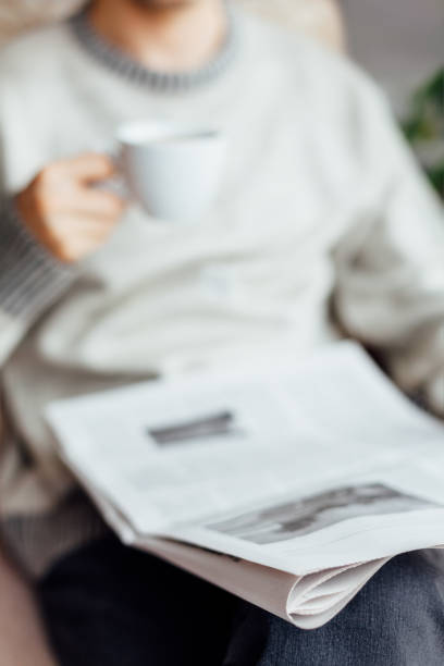 istock Man Sitting And Reading Newspapers 1300158848