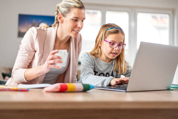 istock Mother and daughter using laptop and learning 1300158878