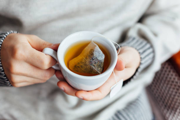 istock Man Holding A Cup Of Hot Tea 1300158898