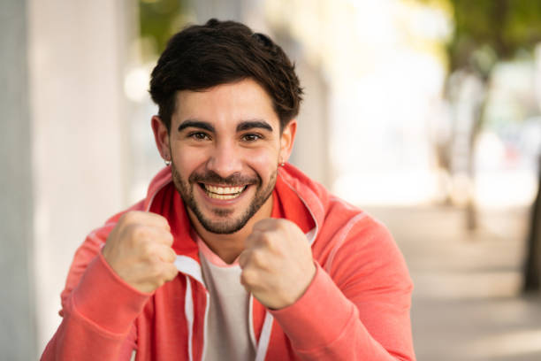 istock Young man celebrating victory outdoors. 1300159325