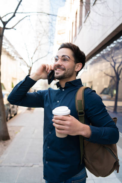 istock Young man talking on the phone outdoors. 1300159335