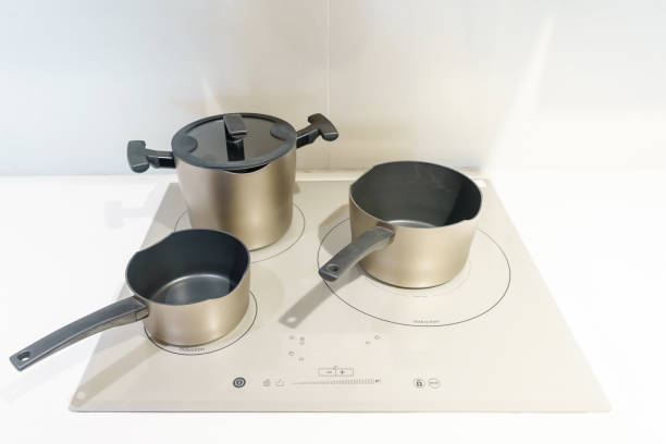 istock Metal Pot on induction hob in modern kitchen. modern kitchen pot cooking induction electrical stove hob concept 1300159638