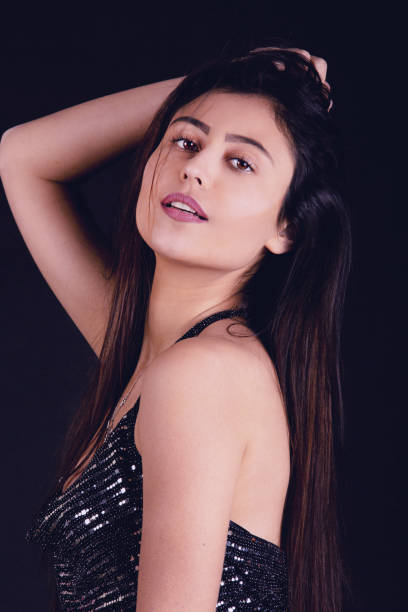 istock Party girl studio shoot wearing sequins top 1300161343