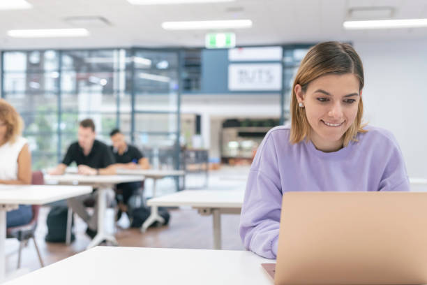istock Millennial woman working on laptop computer 1300161938