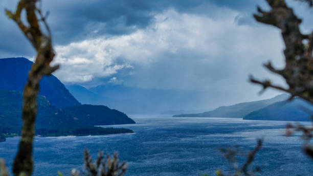 Landscape of lake Lacar Landscape of lake Lacar on a stormy afternoon. San Martin de los Andes, Neuquen, patagonia. Taken from the top of a hill looking to the large and a few mountains behind under a clouded sky. Shooted on a cold summer afternoon lácar lake photos stock pictures, royalty-free photos & images
