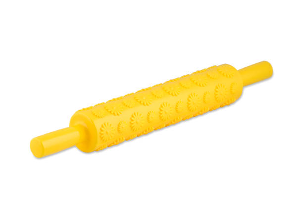 istock Yellow silicone rolling pin with flowers isolated on white background, copy space. 1300164415