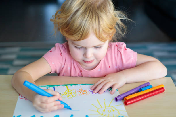 istock Child drawing with colored markers. 1300164417