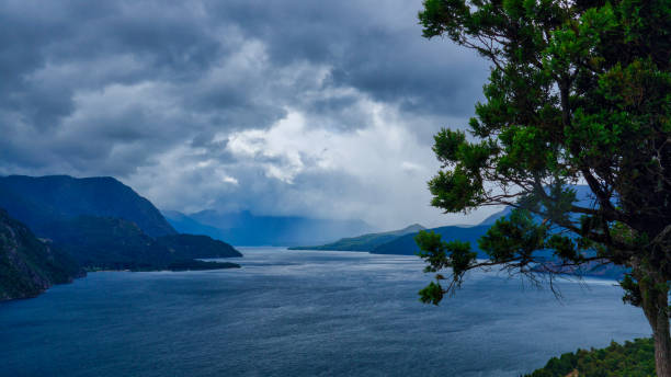 Landscape of lake Lacar Landscape of lake Lacar on a stormy afternoon. San Martin de los Andes, Neuquen, patagonia. Taken from the top of a hill looking to the large and a few mountains behind under a clouded sky. Shooted on a cold summer afternoon lácar lake photos stock pictures, royalty-free photos & images