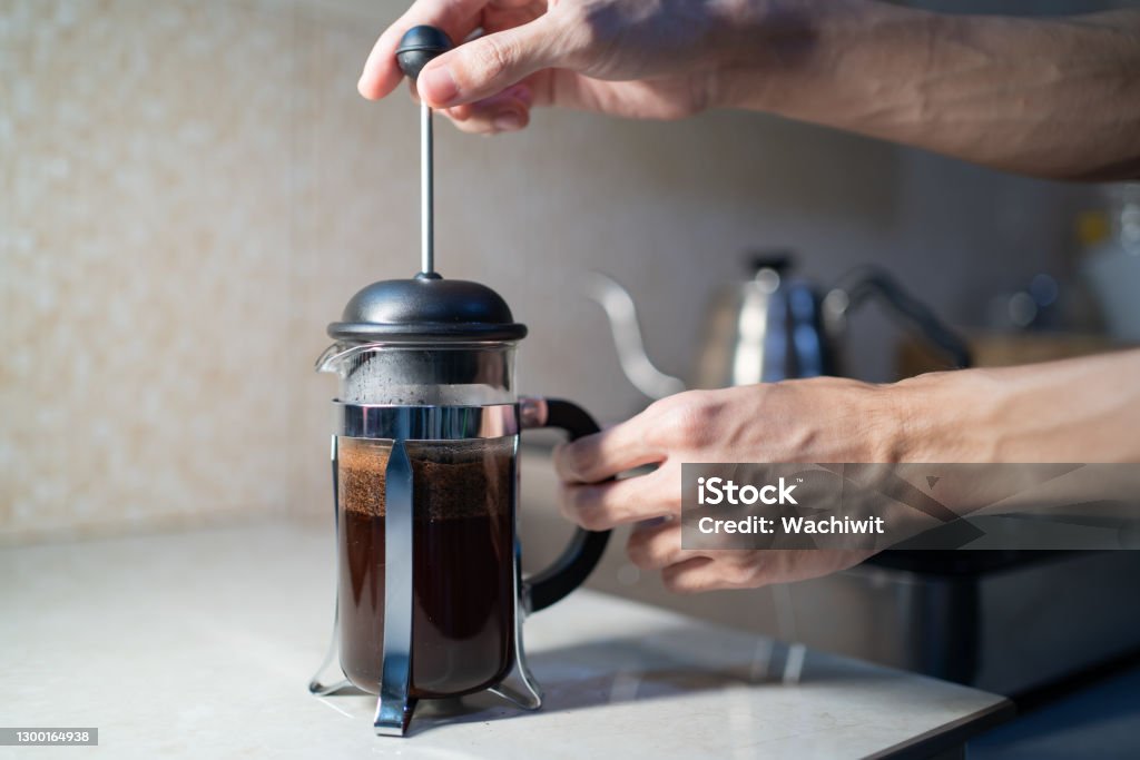 Making French Press coffee in the kitchen French Press Stock Photo