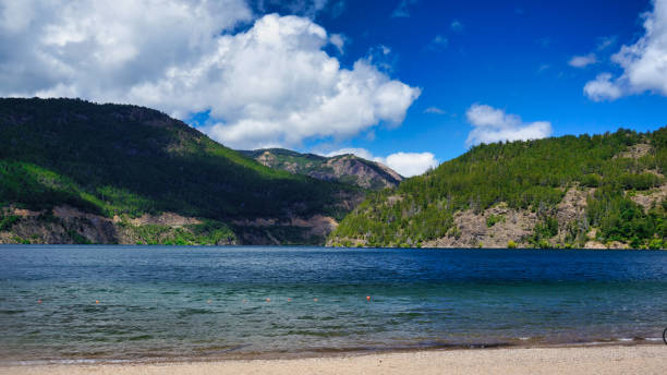 Lake Lacar Landscape of lake Lacar and a few green hills behind, San martin de los Andes, Neuquen, Argentina. Taken on a warm summer afternoon under a ble sky with a few white clouds from the beach lácar lake photos stock pictures, royalty-free photos & images