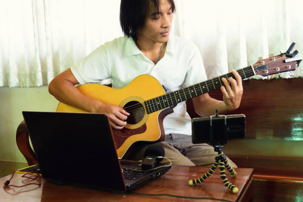 istock musician live streaming playing guitar show from home 1300166420