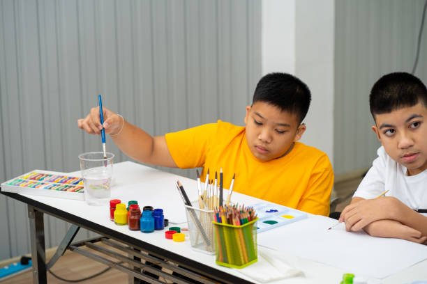 asian disability children with autism girl learning color paint in classroom - 3500 imagens e fotografias de stock