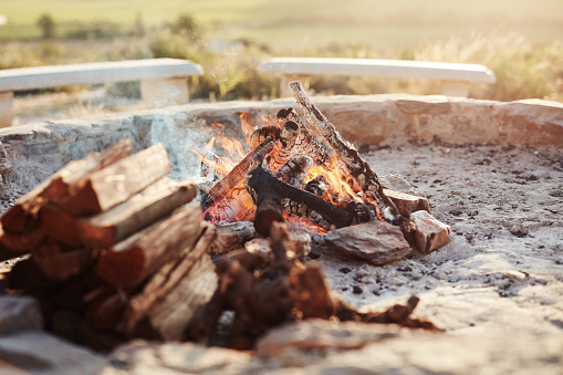 Shot of a log fire in an outdoor fireplace