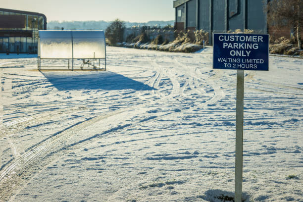 istock customer parking only sign post over empty parking space covered with winter snow in england uk 1300168497