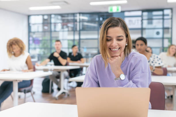 istock Smiling millennial woman working on laptop computer 1300168627