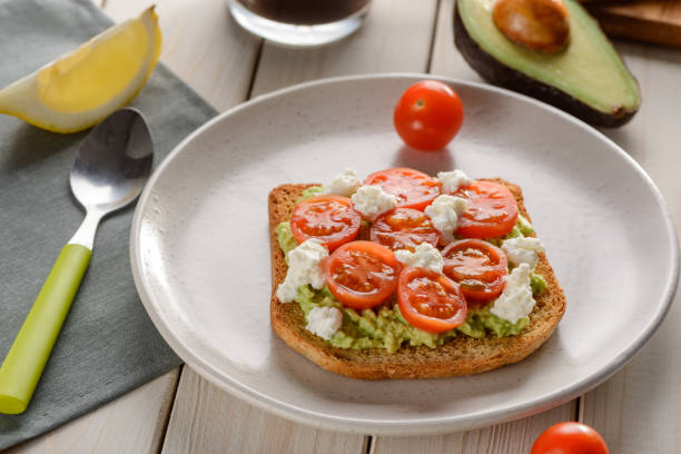 istock Toast with tomato, ricotta and avocado. Good-looking snack 1300171717