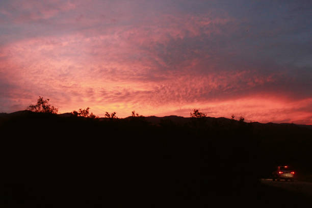 istock Car drives into sunset in Colombia 1300172021